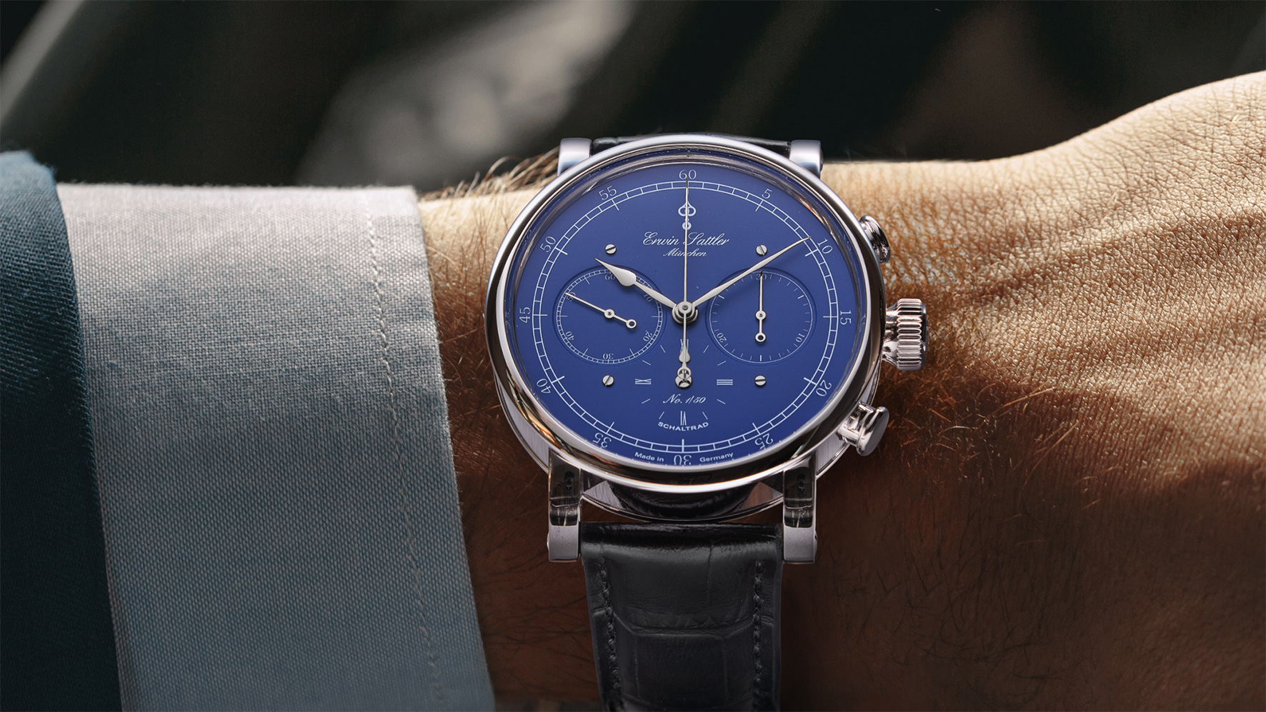 Close up portrait of unrecognized male looking at luxury watch on hand and checking the time